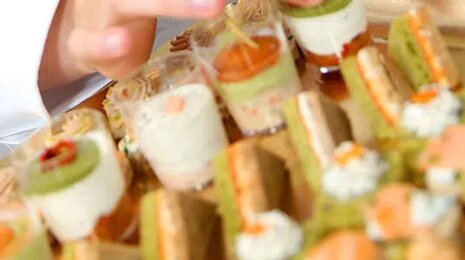 Assorted gourmet appetizers and finger foods arranged on a serving tray.