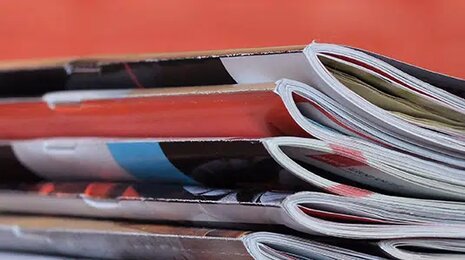 Stack of magazines piled neatly on top of each other.