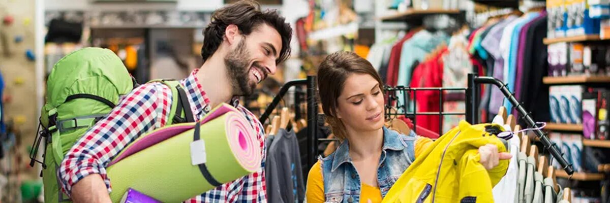Man and woman shopping in a sports shop - symbolises the process behind where EDI for Sport 2000 comes into play.