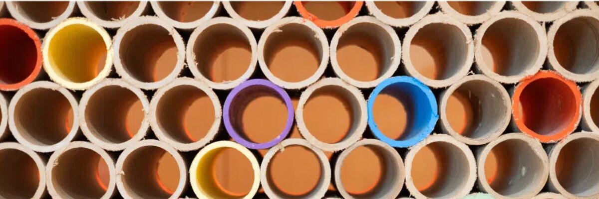 Stacked tubes with colored interiors forming circular patterns, symbolizing diversity and structure