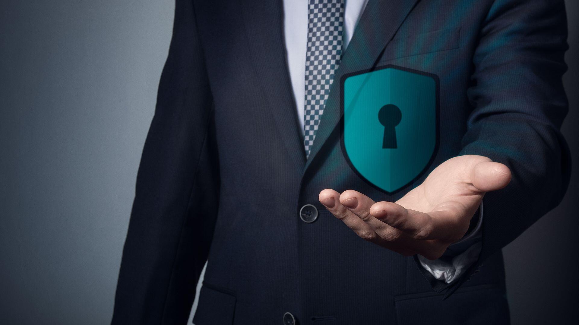 Business professional holding a digital padlock symbolising information security and secure digital communication.