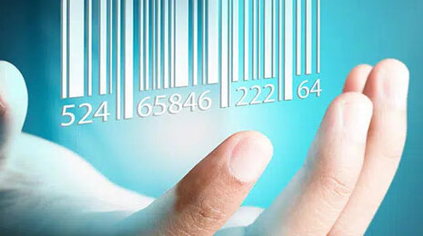 Open hand held up beneath a glowing digital barcode, symbolizing product identification, data capture, and digital inventory management.