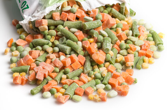 © iStockphoto/Juanmonino Close-up of an open bag of frozen vegetables