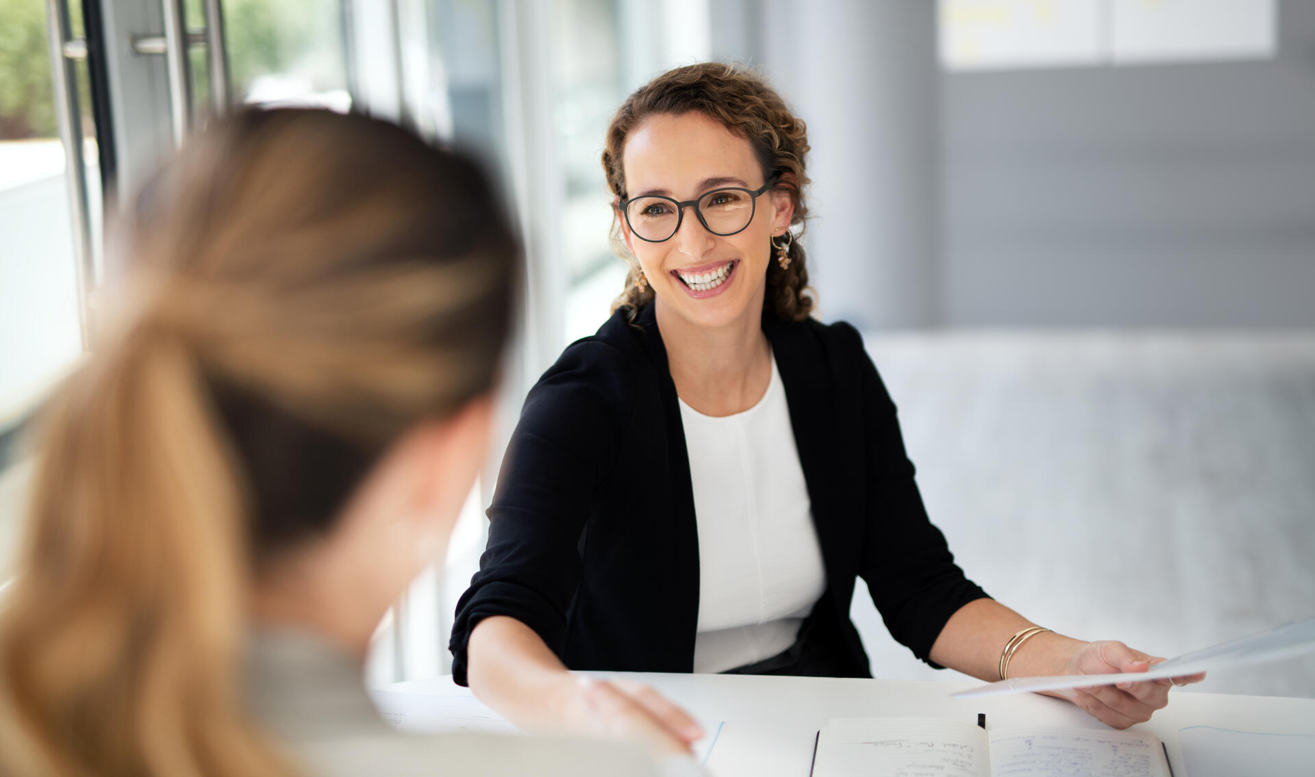 Shot of two businesswomen shaking hands in a modern office
