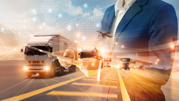 Digital logistics concept with trucks, a businessman, and network lines representing supply chain flow