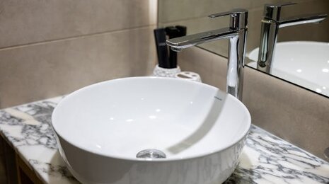 A white circular bathroom sink