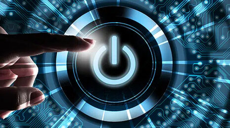 Hand operates the power button to start the digital processes for example with Web-EDI for SMEs