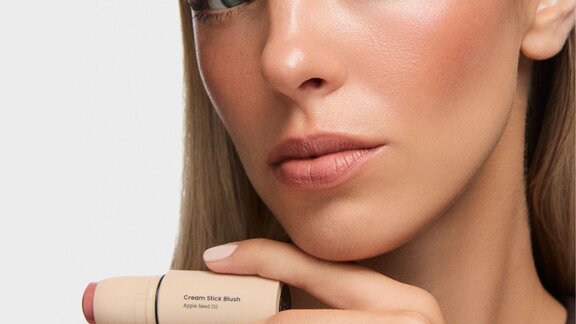 woman holding a blush stick in her hand