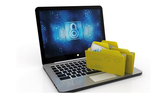 Laptop displaying a digital padlock symbol on the screen, with yellow file folders next to it