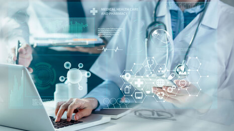 © iStockphoto / SOMKID-THONGDEE Medical professionals using technology, with digital health icons and graphics overlaying the image, representing modern healthcare, data analysis, and medical innovation